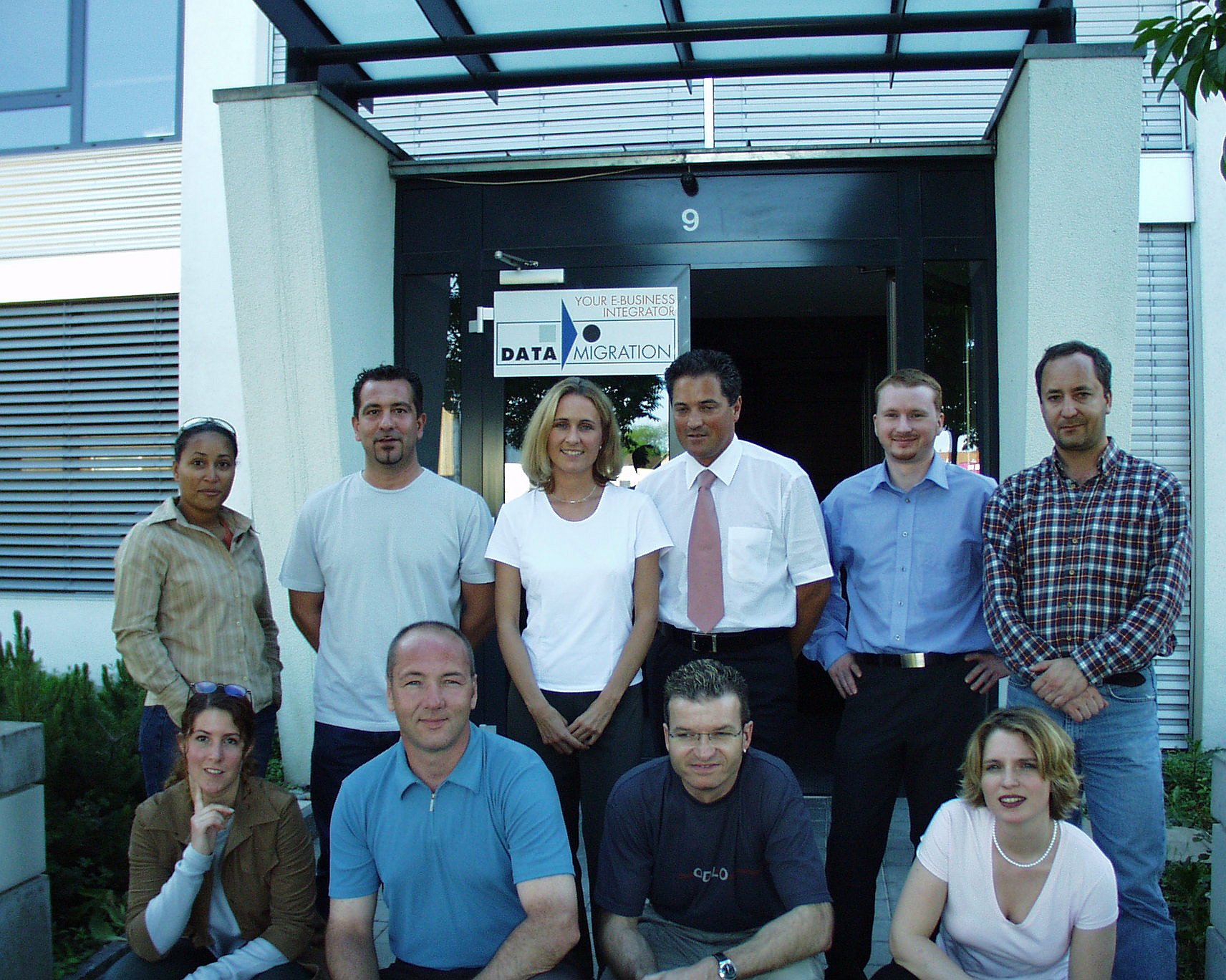 The first Data Migration team gathered at the office entrance